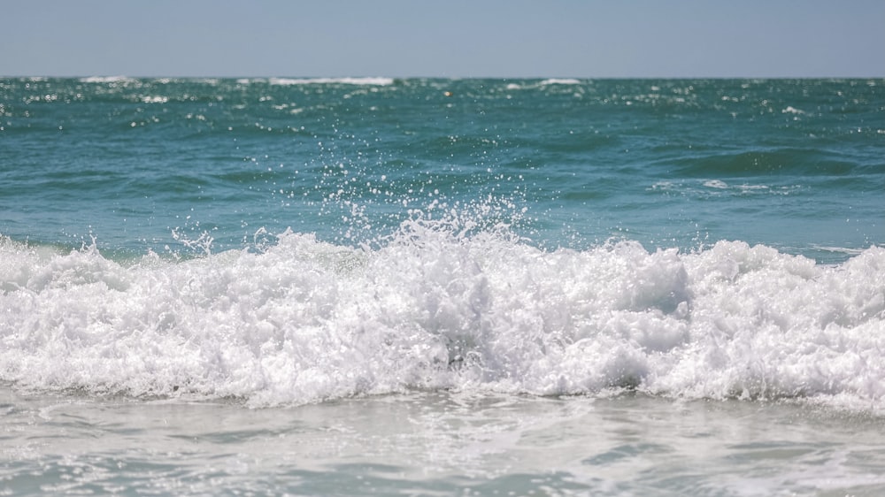 a person riding a surfboard on a wave in the ocean