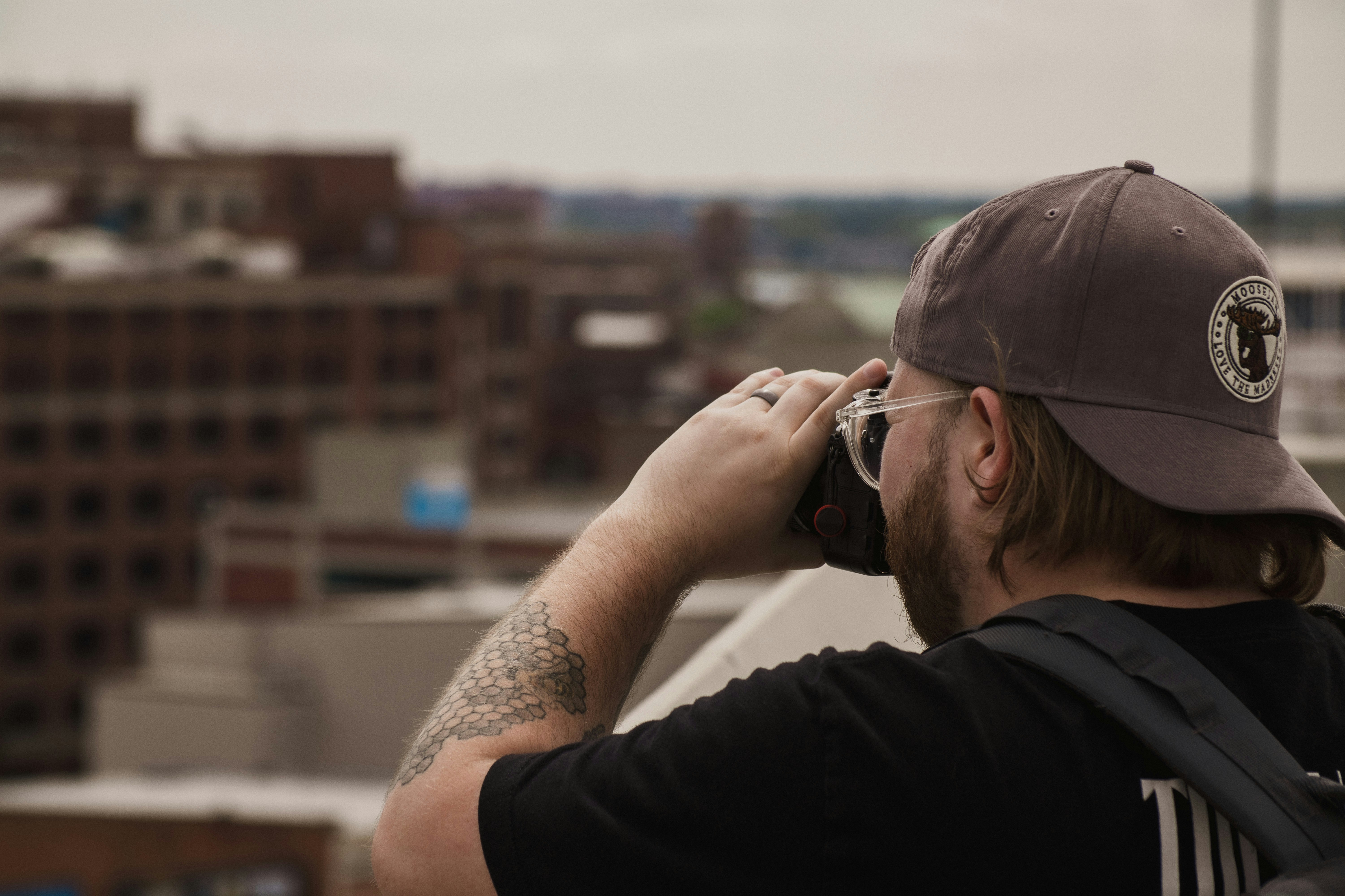 a man with a beard talking on a cell phone