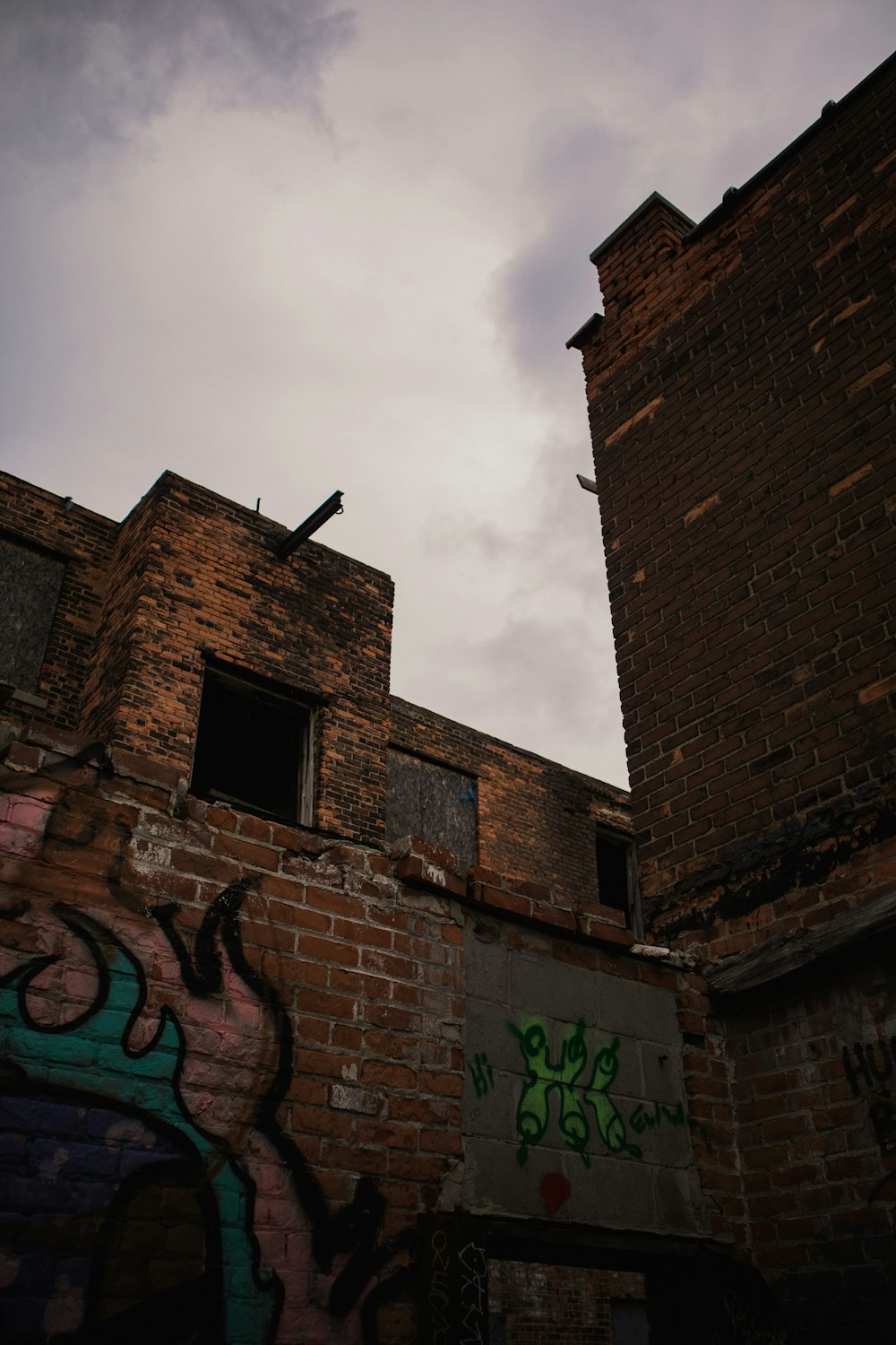 an old brick building with graffiti on it