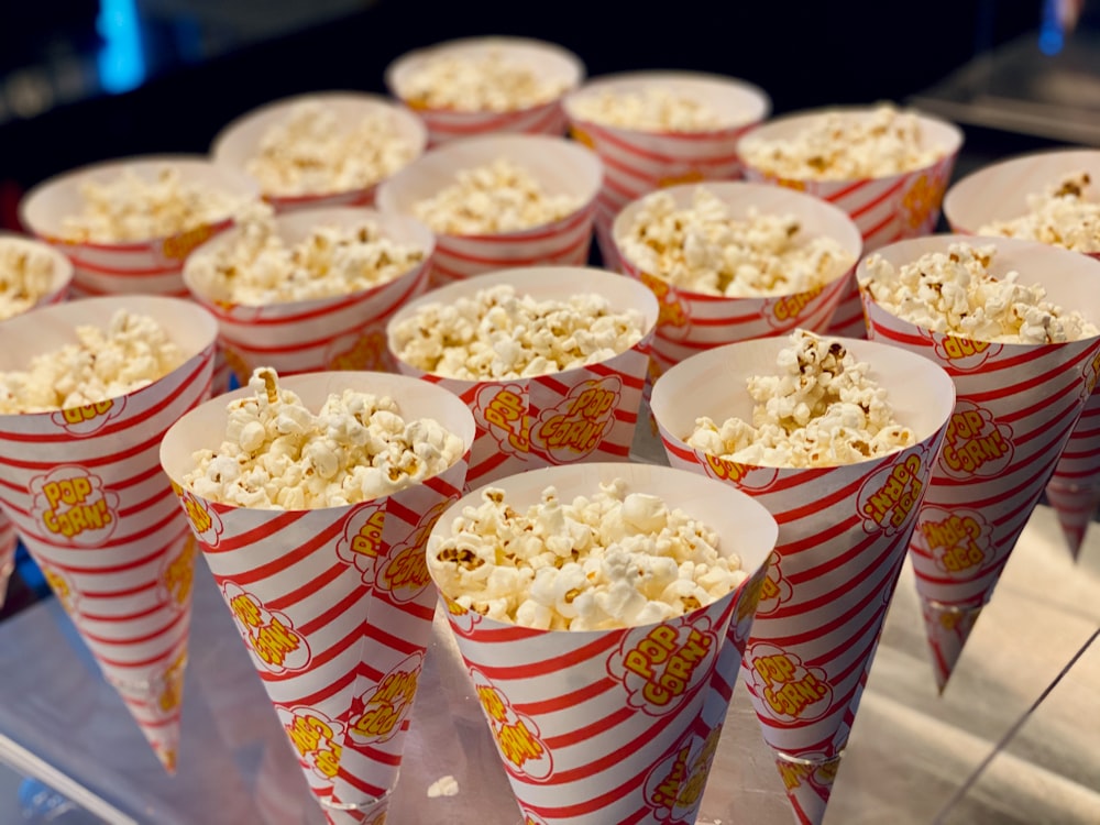 a bunch of popcorn cups that are on a table