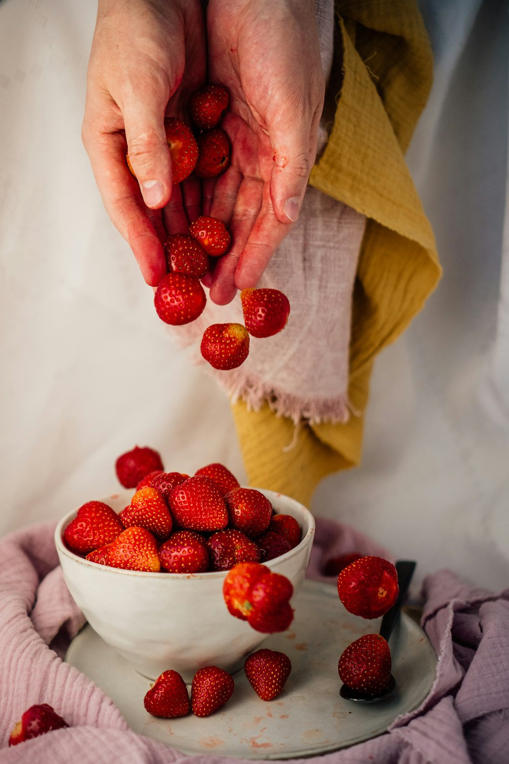 person holding red raspberry fruit