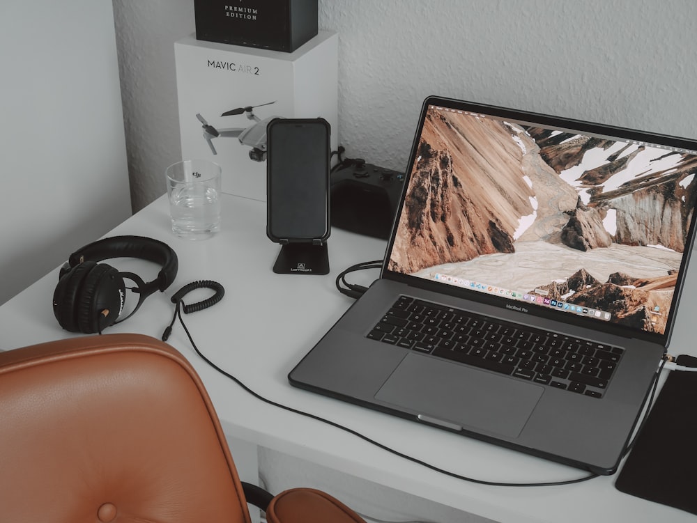 a laptop computer sitting on top of a white desk