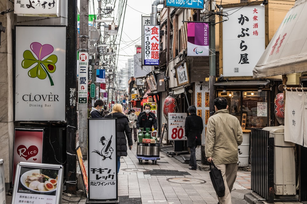 昼間、歩道を歩くグレーのジャケットを着た男性