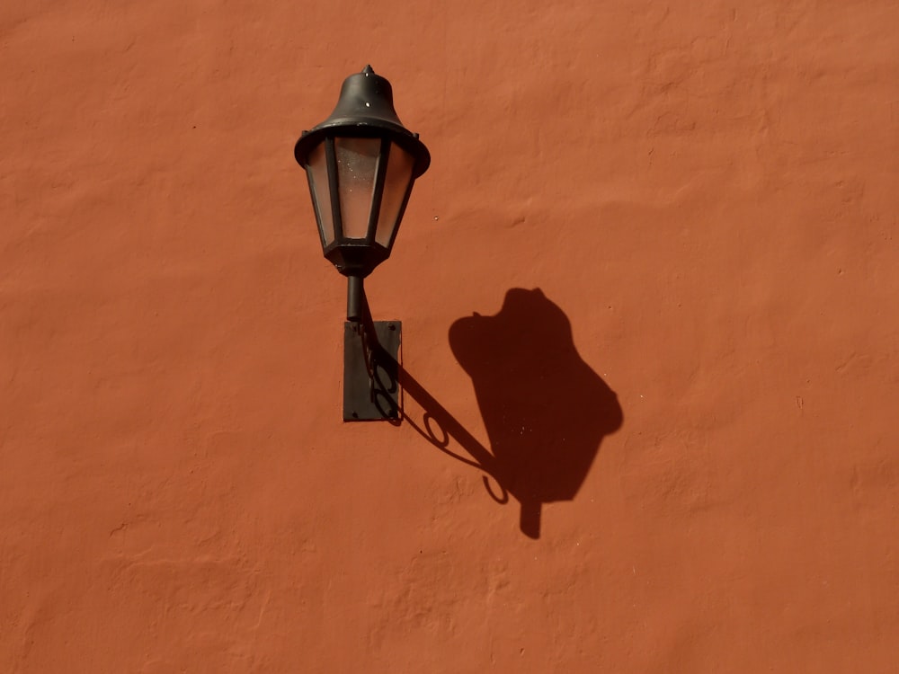 a shadow of a lamp on a wall