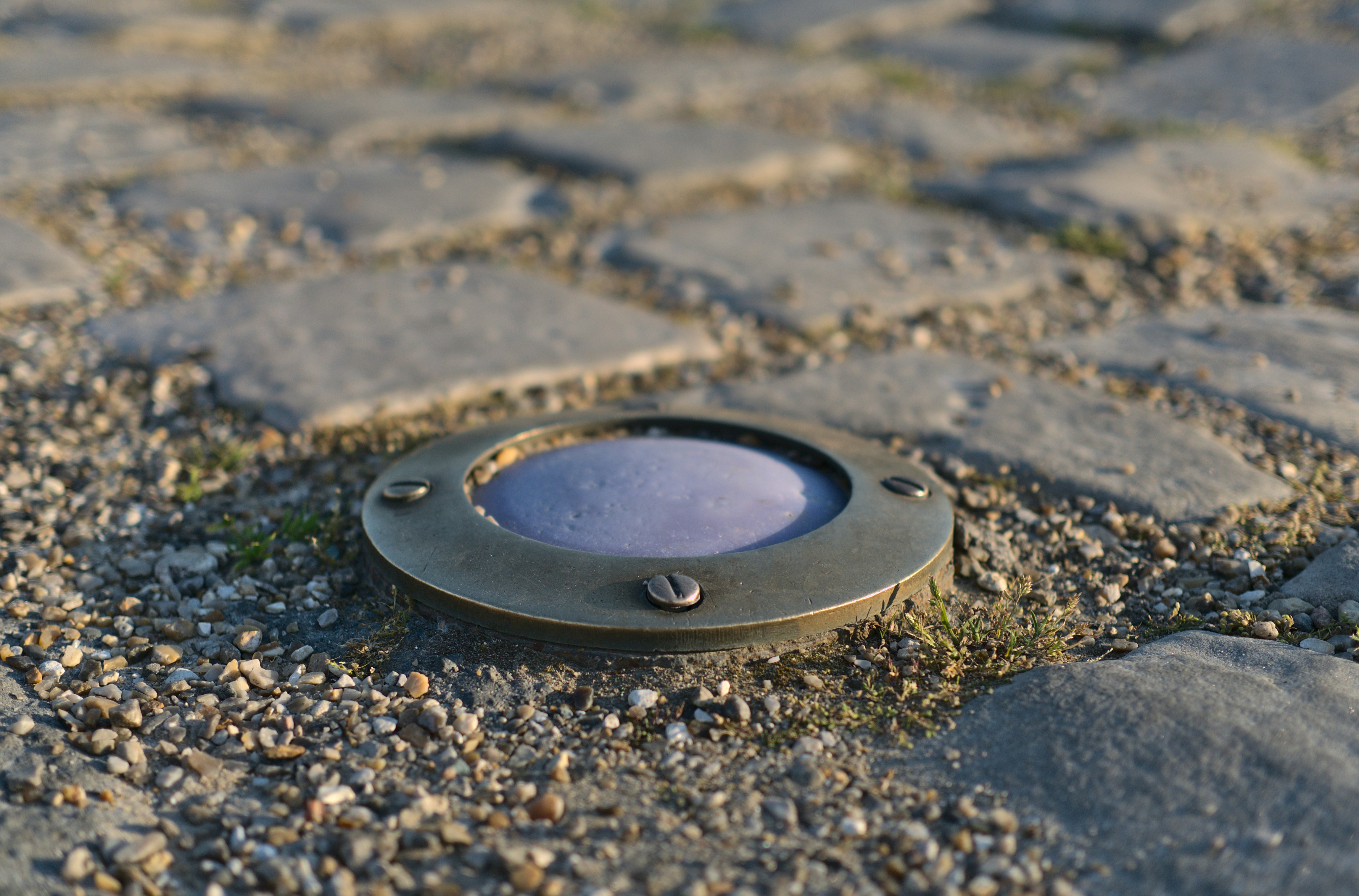 A close up of a metal object on the ground photo – Free Sewer Image on ...