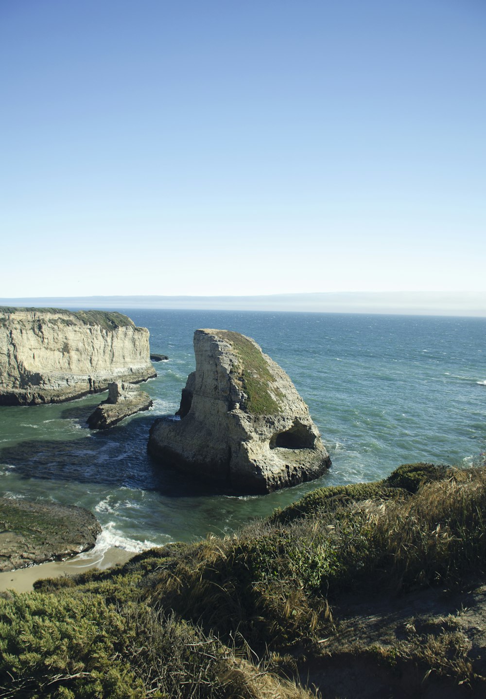 gray rock formation on sea during daytime