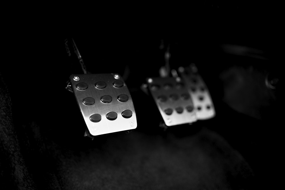 a pair of dice earrings hanging from a hook