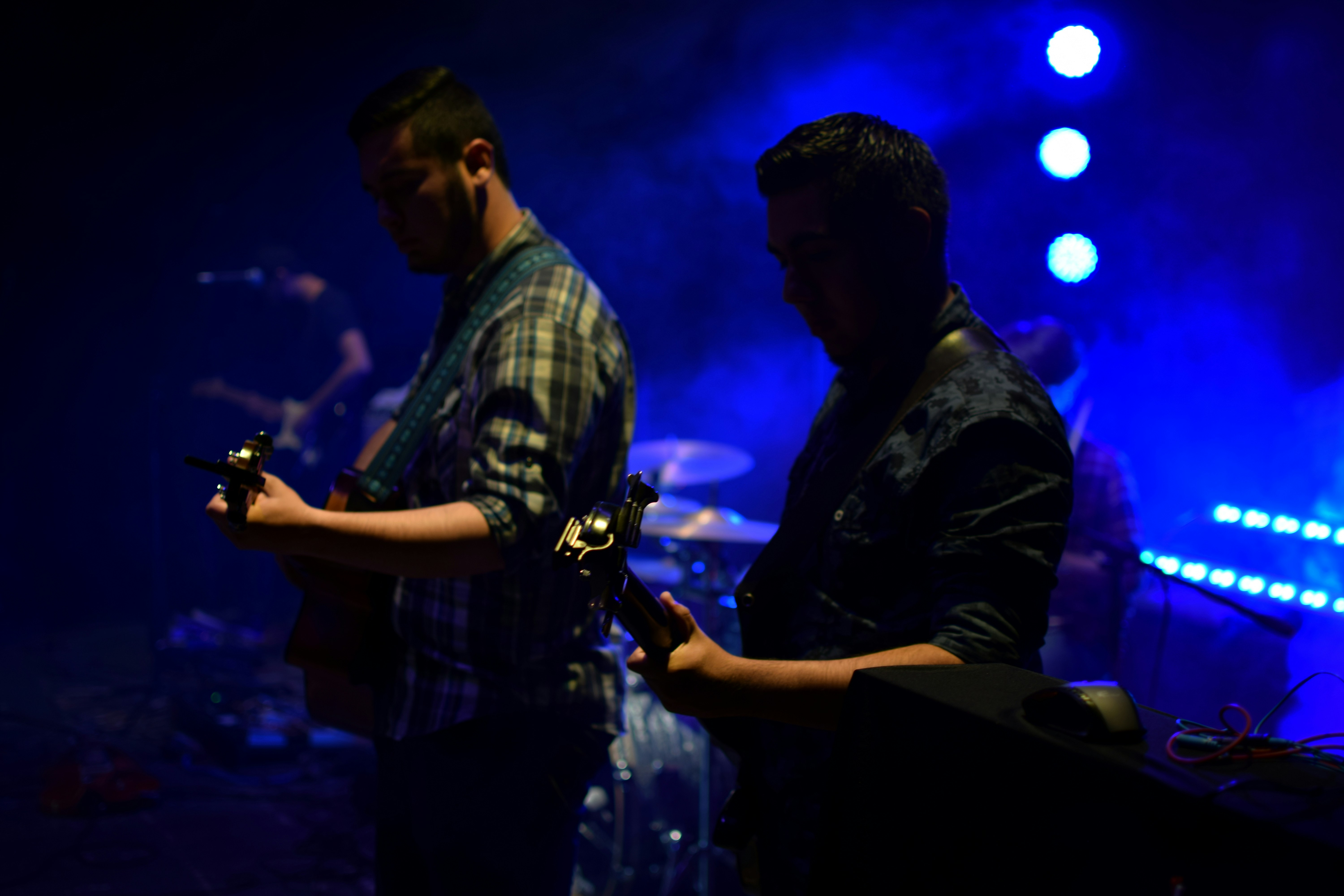 a couple of men standing next to each other on a stage, 