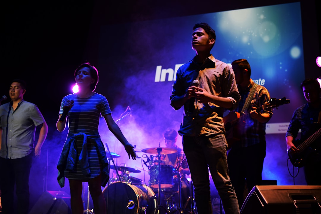 a group of people standing on top of a stage,