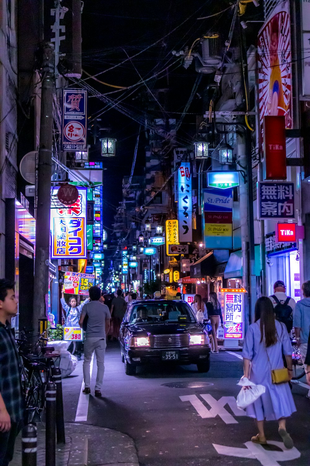 people walking on street during night time