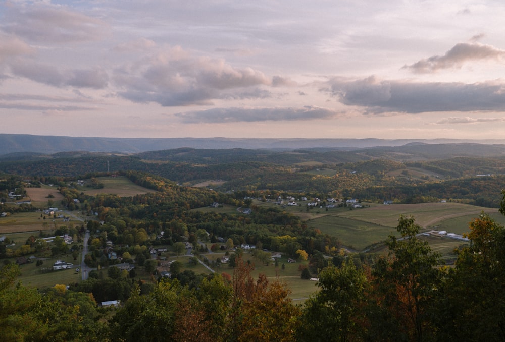 a scenic view of a valley with a town in the distance