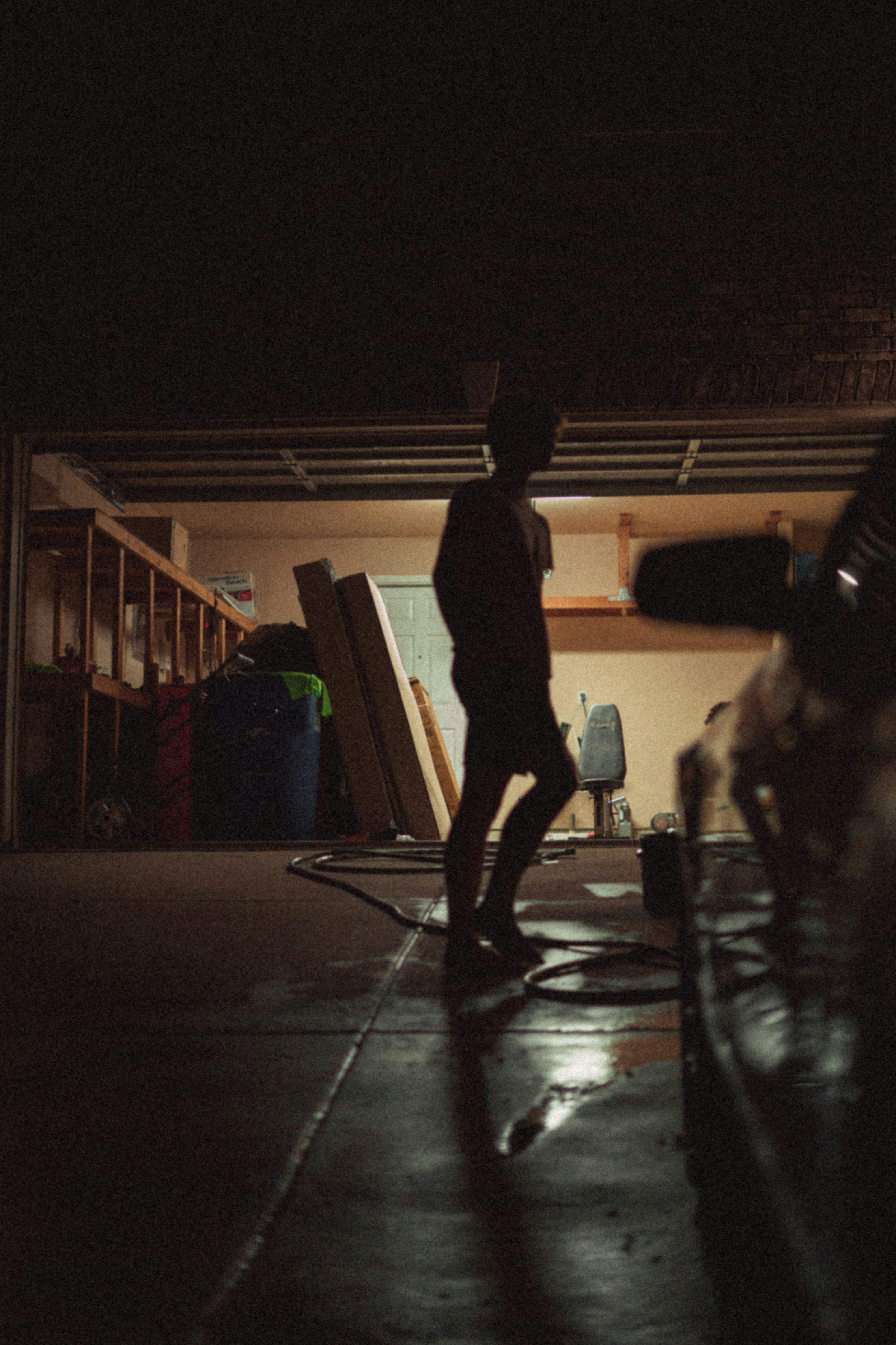 a person standing in a garage at night
