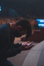 a man sitting down looking at his cell phone