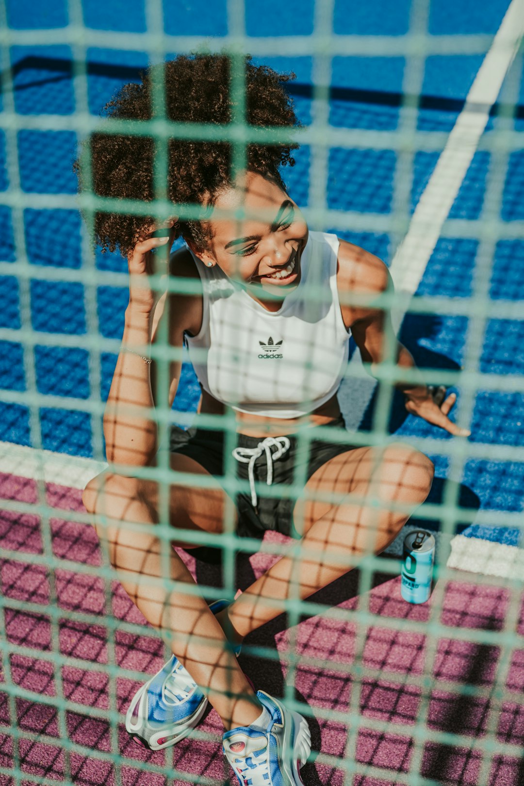 woman in white and red jersey shirt sitting on pink net