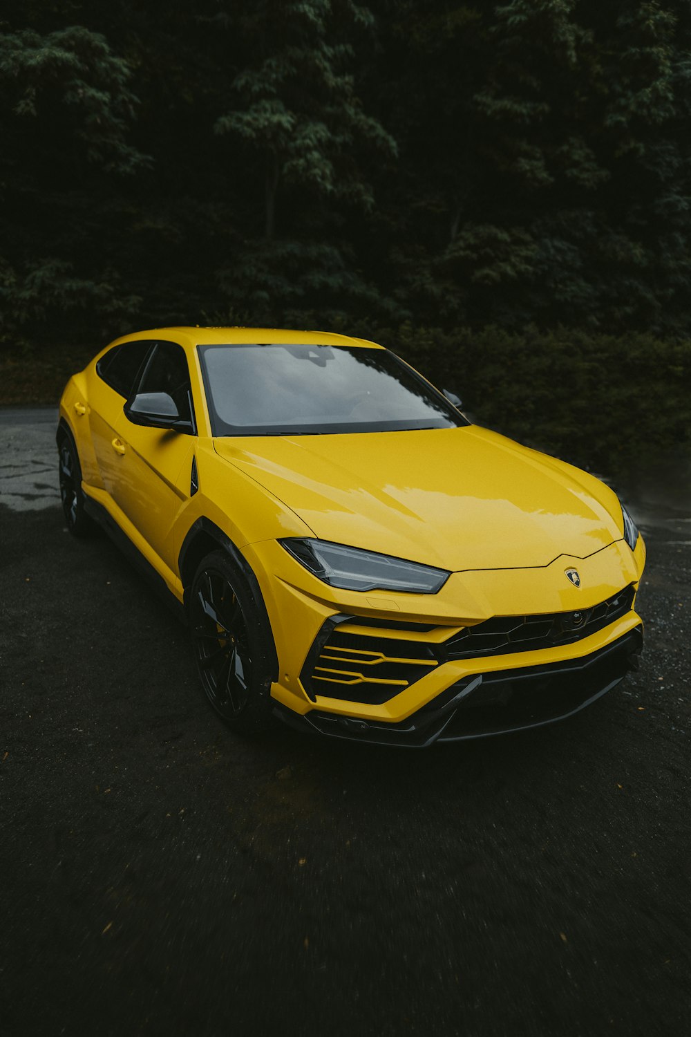 yellow chevrolet camaro on black asphalt road