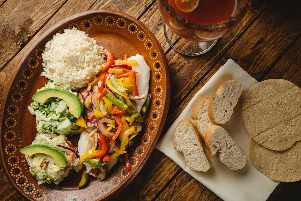 a plate of food on a table next to a glass of beer