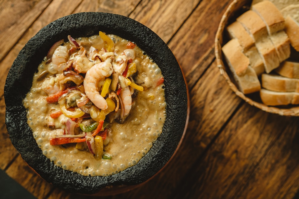 a bowl of food on a wooden table