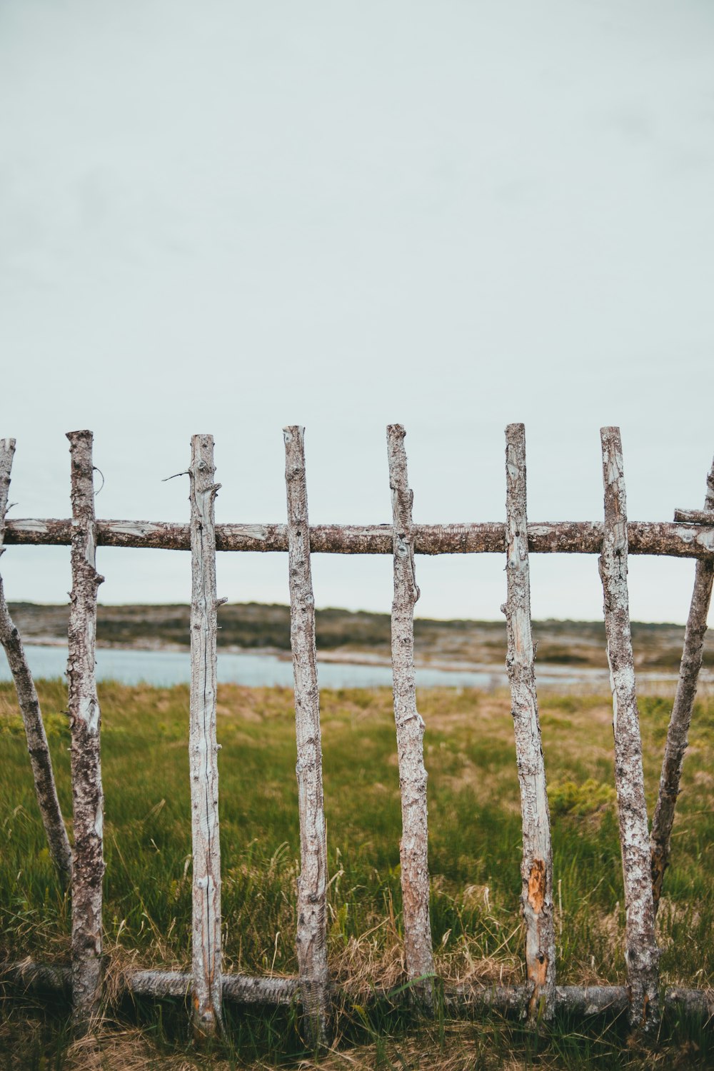 an old wooden fence in a grassy field