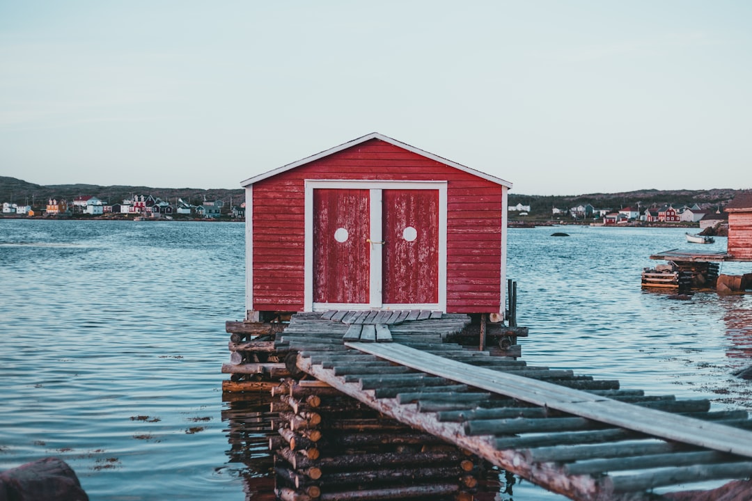 red wooden house on dock during daytime