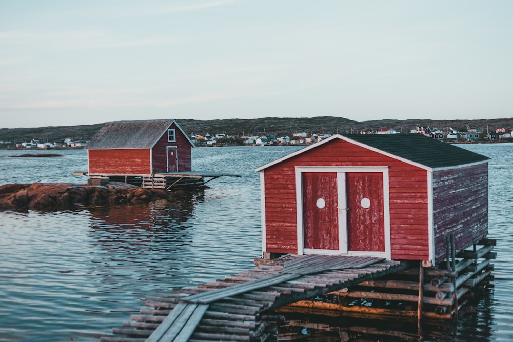 red and white wooden house on dock during daytime