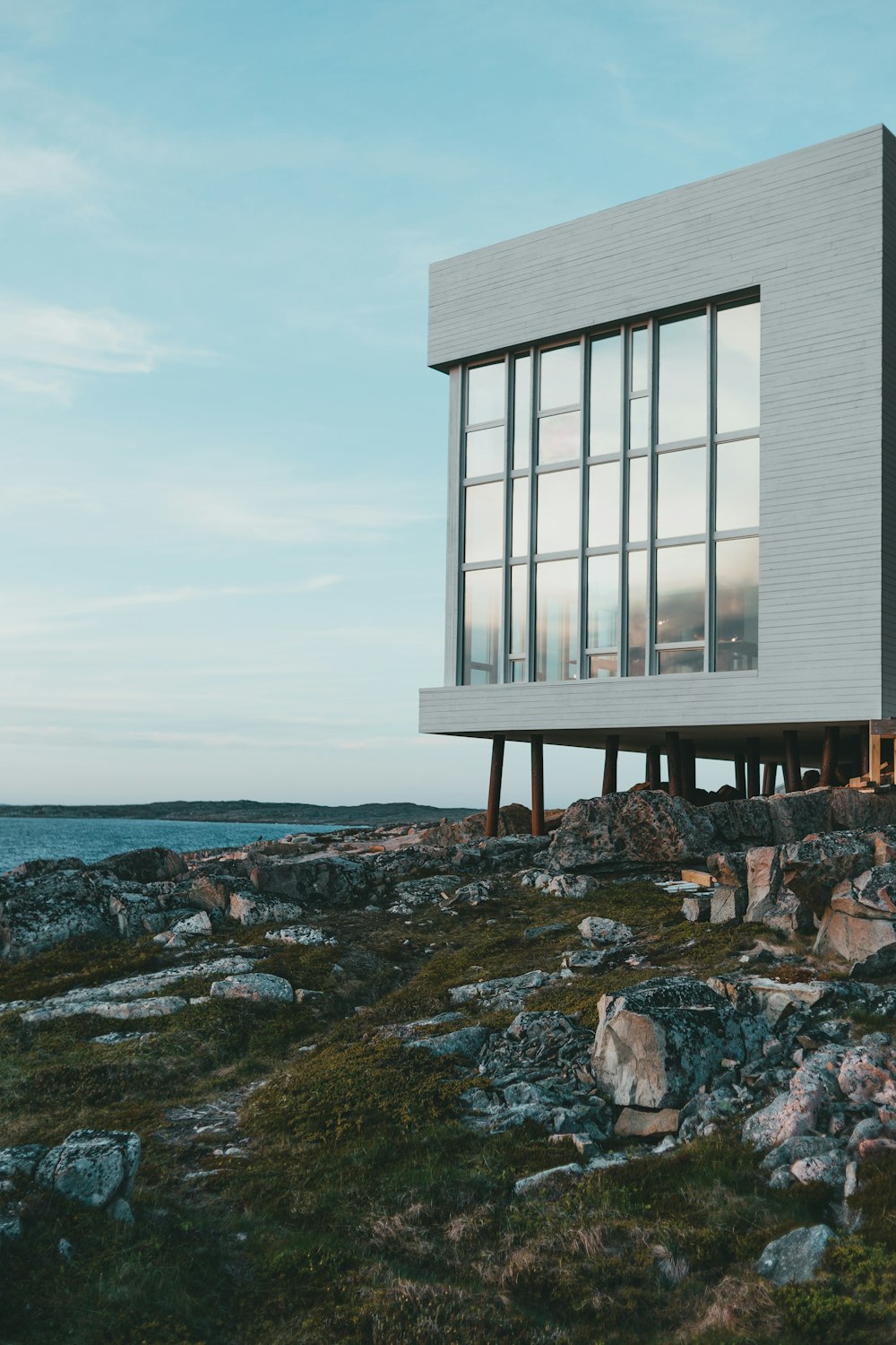 a white building sitting on top of a rocky hillside