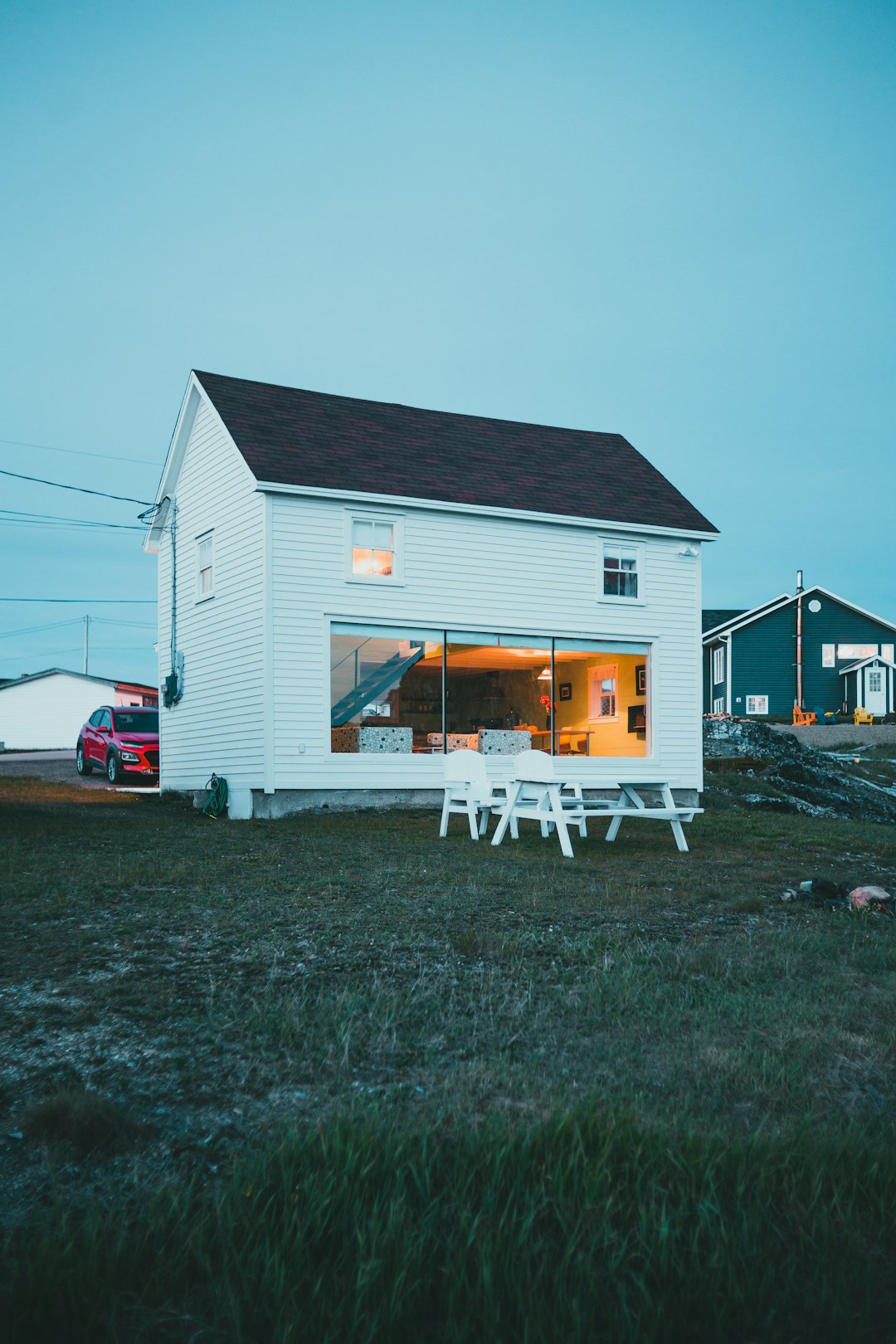 white wooden house near green grass field during daytime