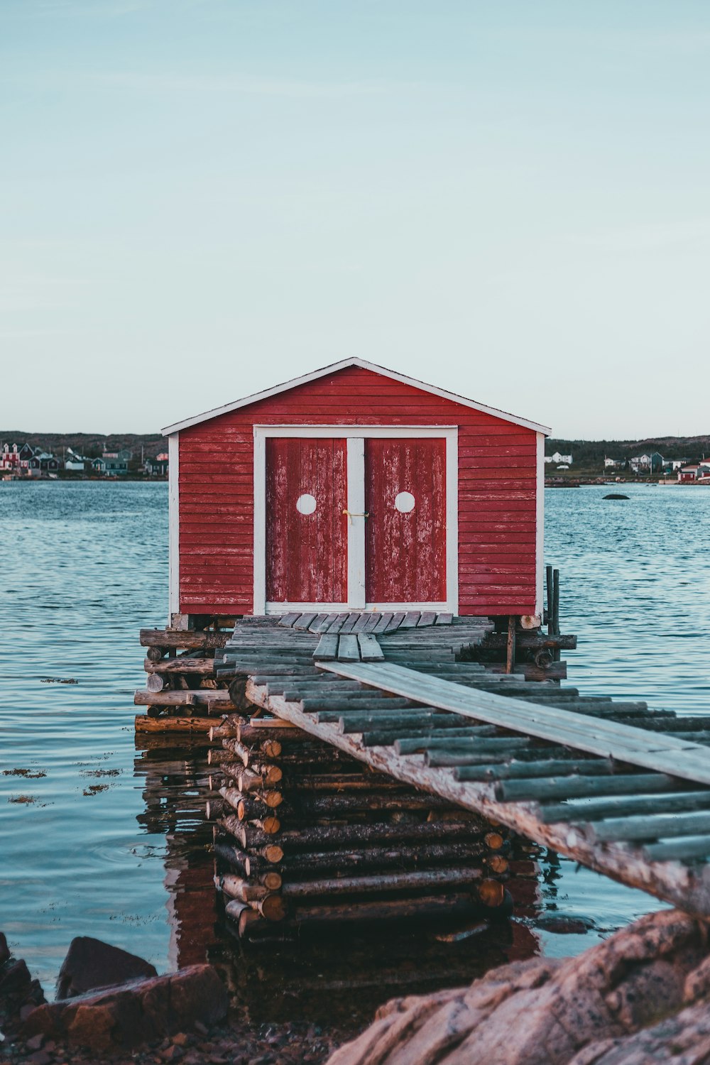 red wooden house on dock during daytime