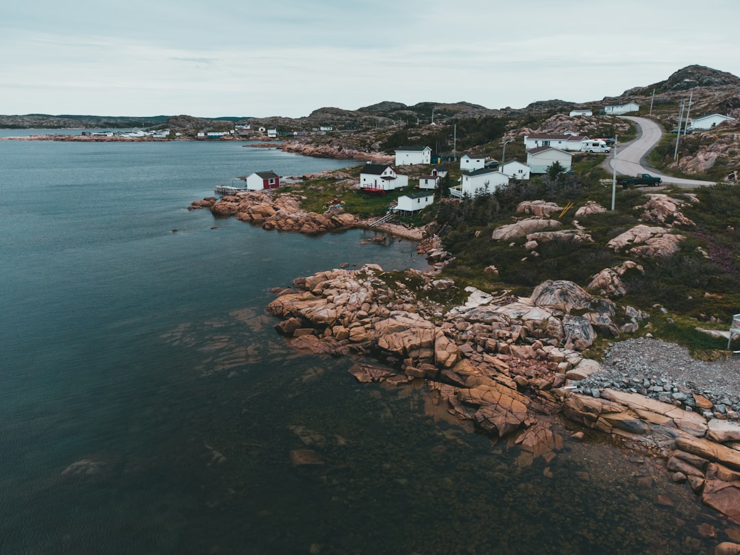 brown rock formation beside body of water during daytime