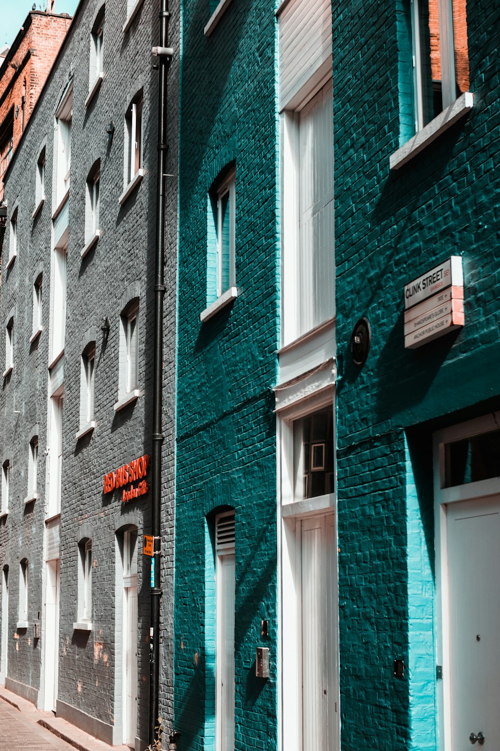 a row of blue brick buildings on a city street