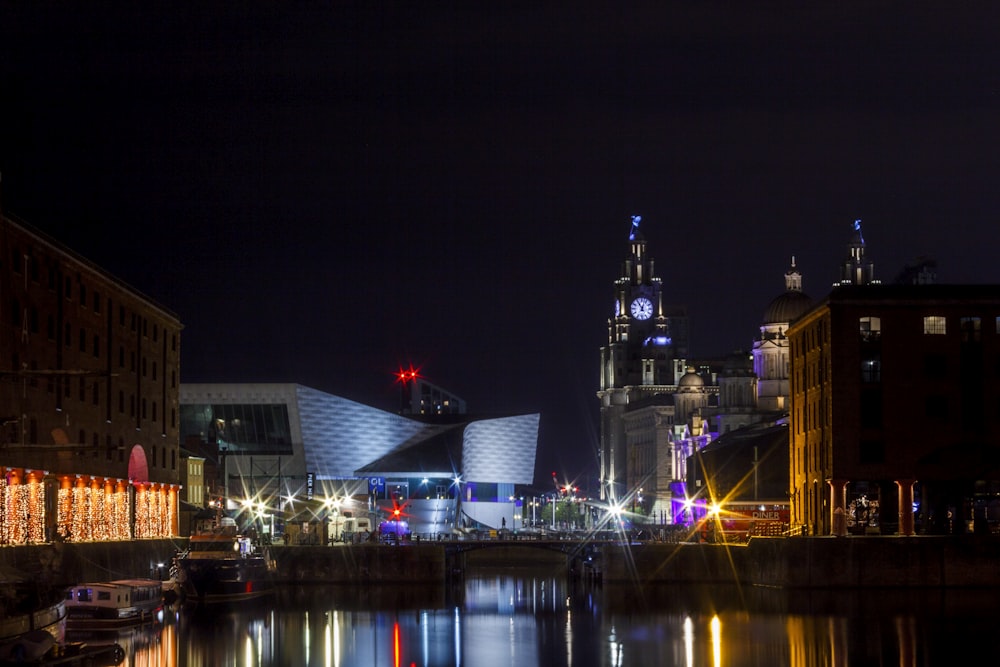 a city at night with lights reflecting in the water