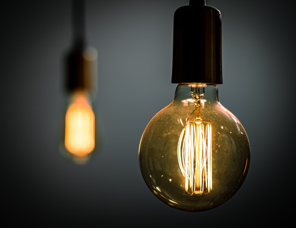 a couple of light bulbs hanging from a ceiling