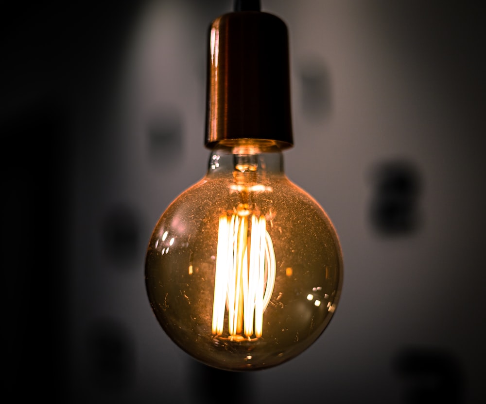 a light bulb hanging from a ceiling in a dark room