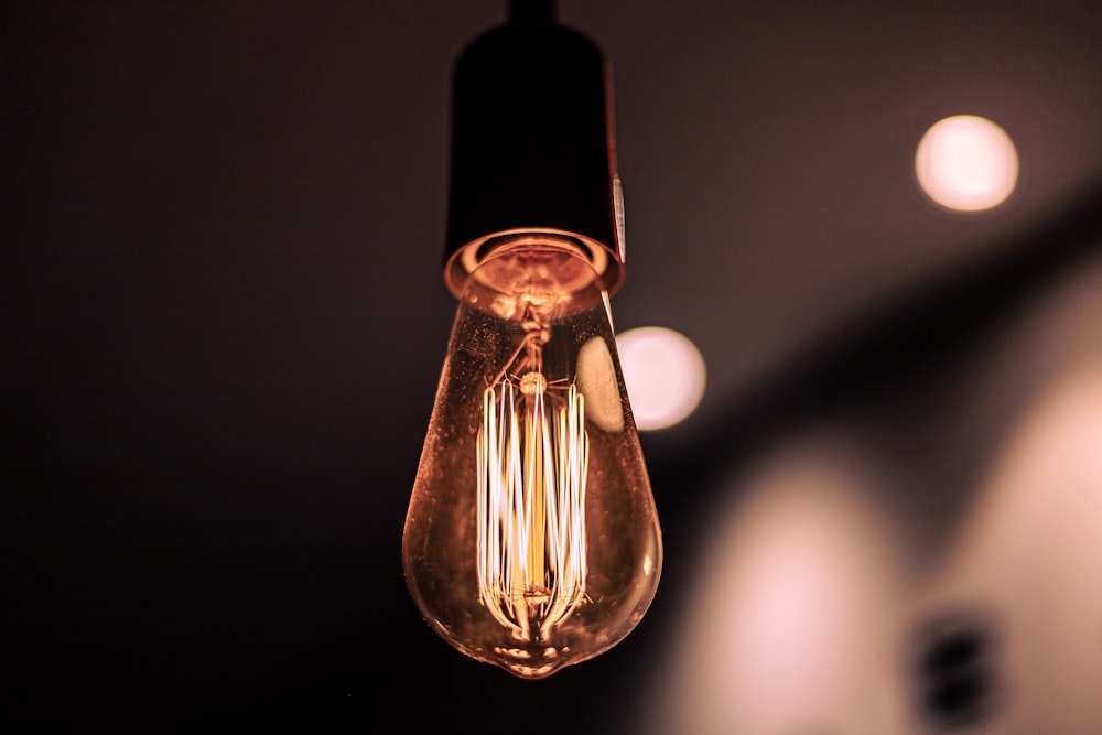 a light bulb hanging from a ceiling in a dark room