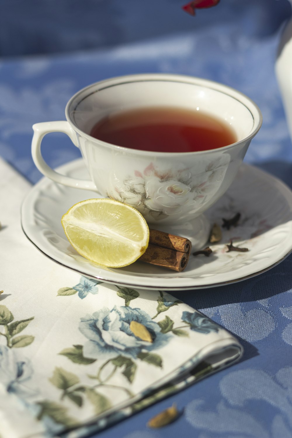 a cup of tea with a slice of lemon on a saucer