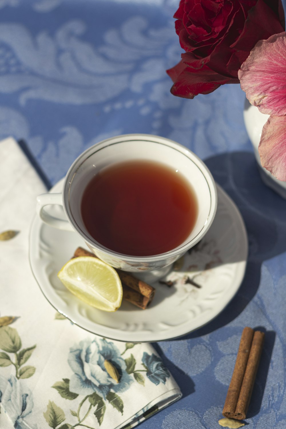 a cup of tea with a slice of lemon on a saucer