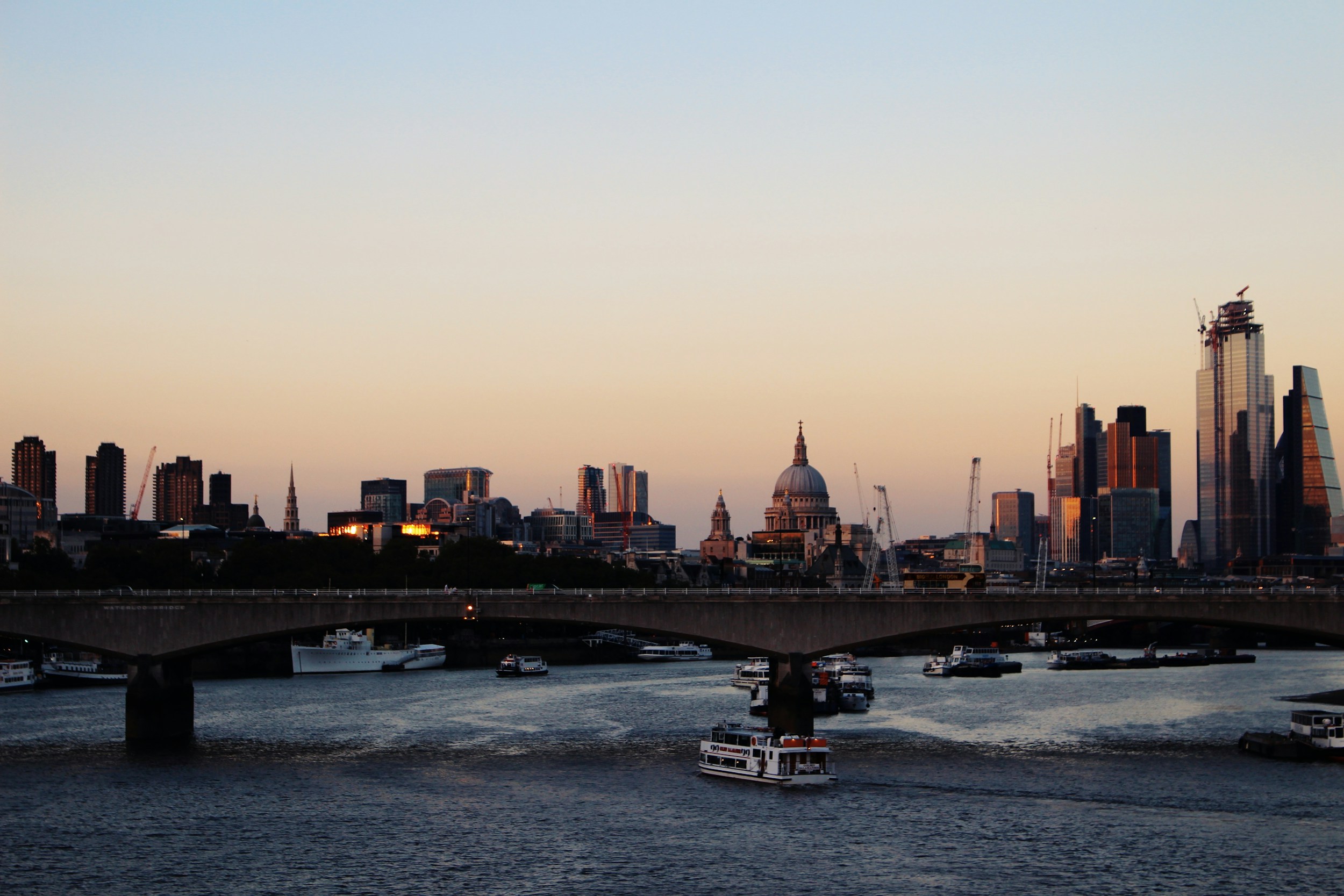 city skyline bridge water daytime