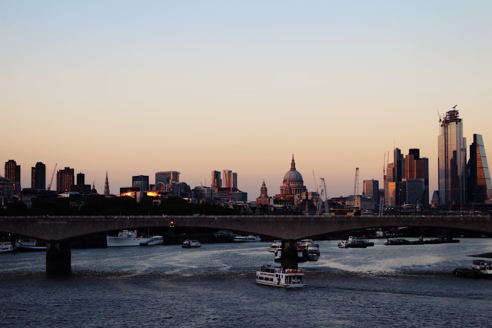 a boat traveling down a river with a city in the background