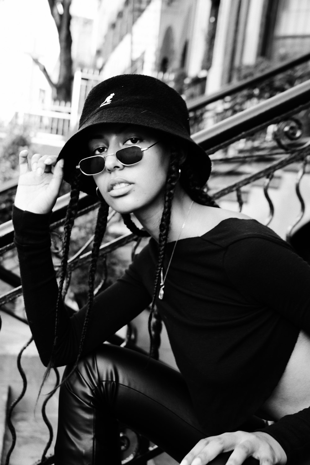 woman in black long sleeve shirt wearing black sunglasses and black hat