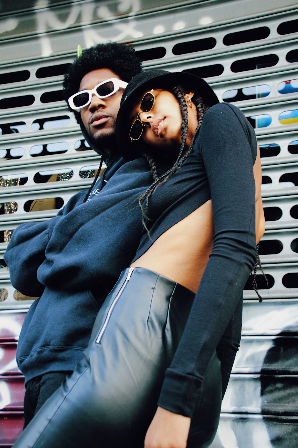 woman in black long sleeve shirt and black skirt wearing black sunglasses