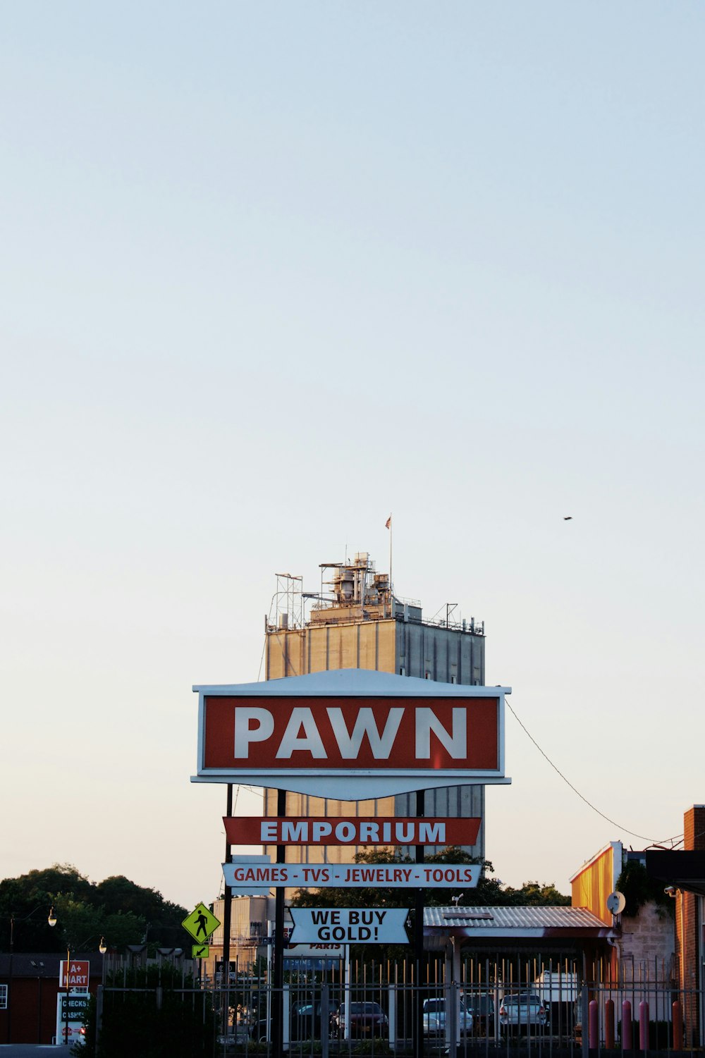 a pawn store sign with a building in the background