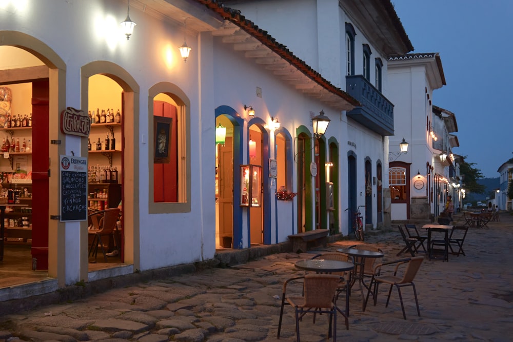 a cobblestone street lined with tables and chairs