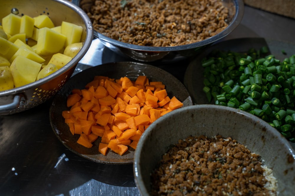 a table topped with bowls filled with different types of food