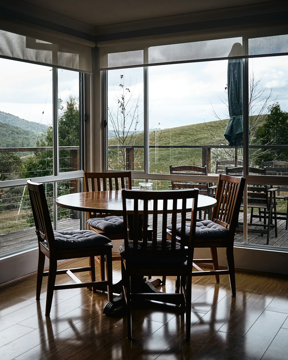 a dining room table and chairs with a view of the mountains