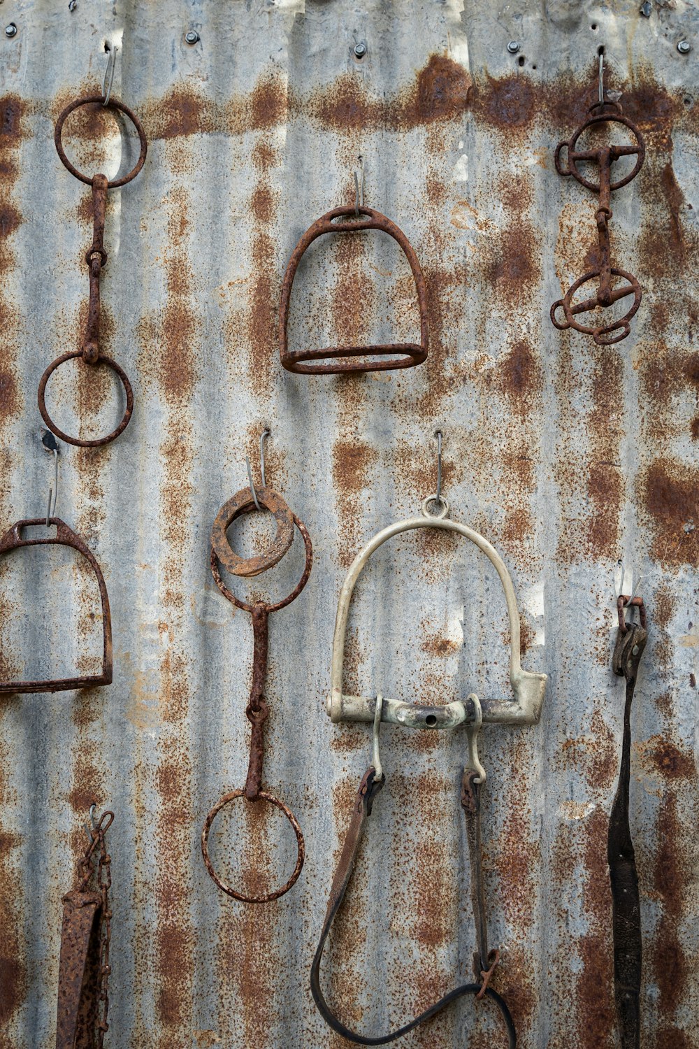 a bunch of rusty metal items on a wall