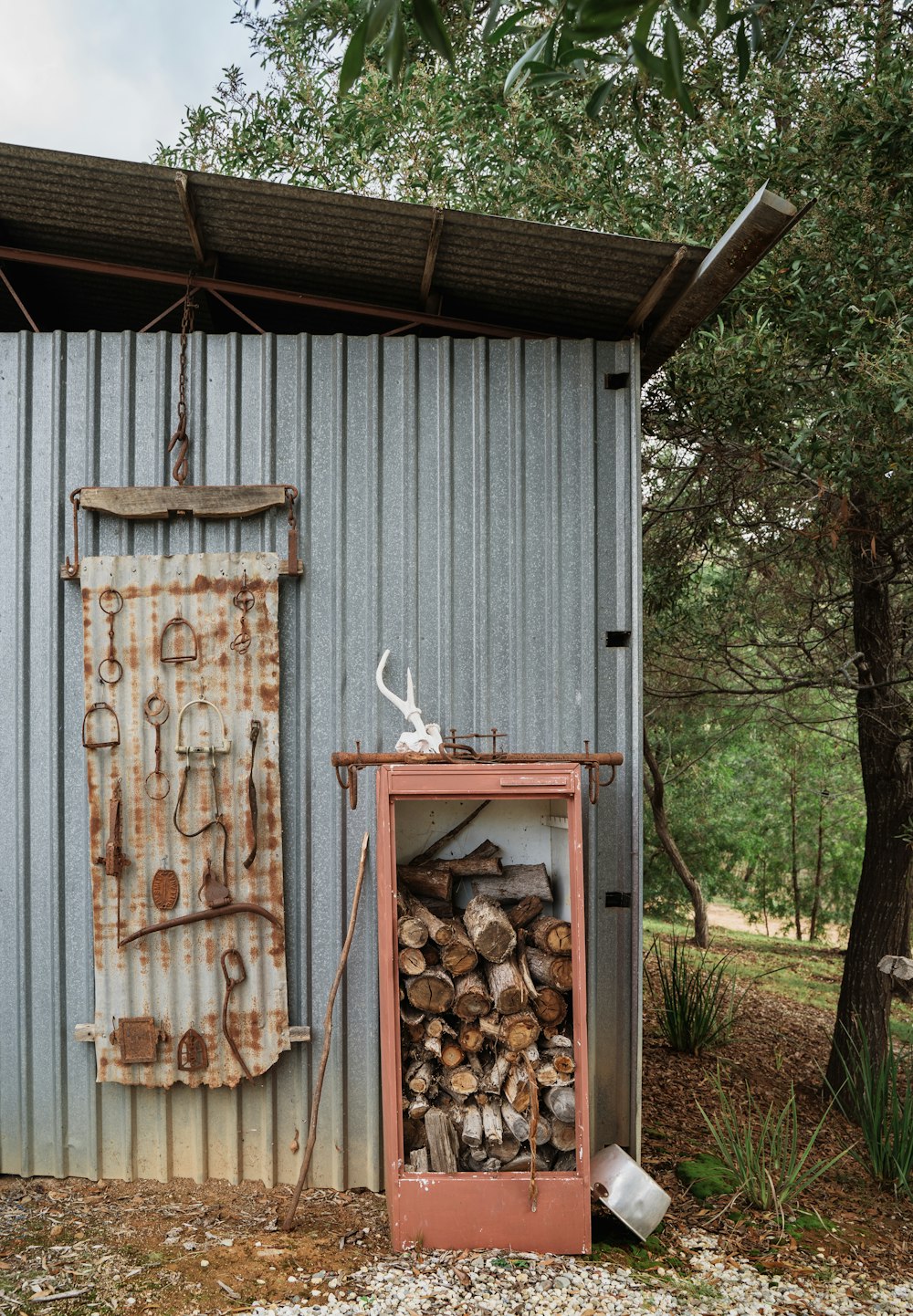 a pile of wood sitting next to a building