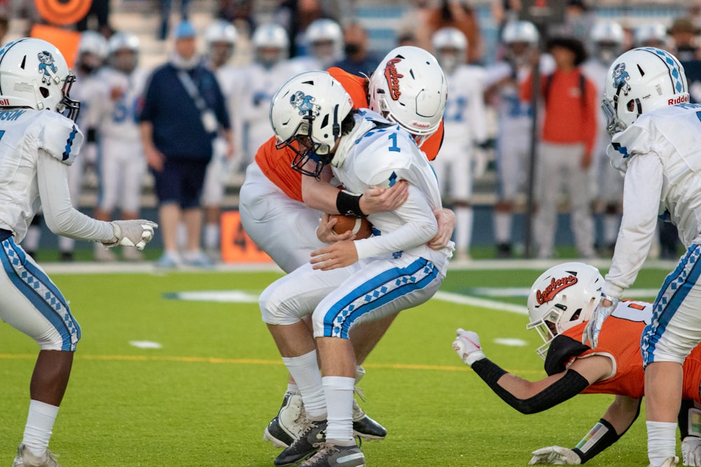 football players on field during daytime