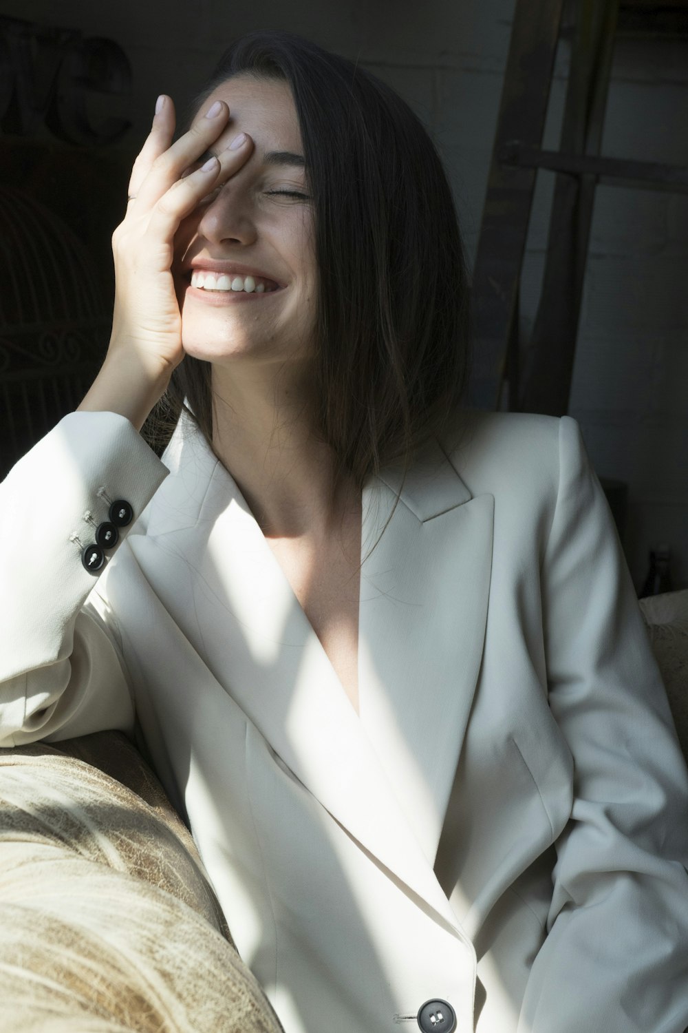 woman in white blazer smiling