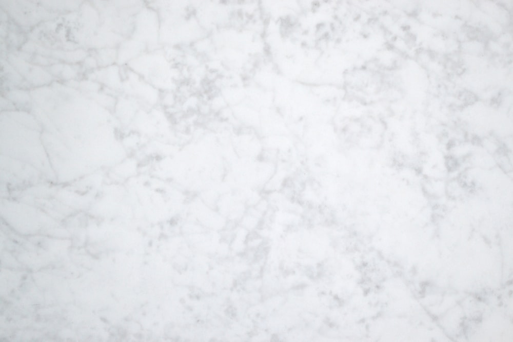 a close up of a white marble surface