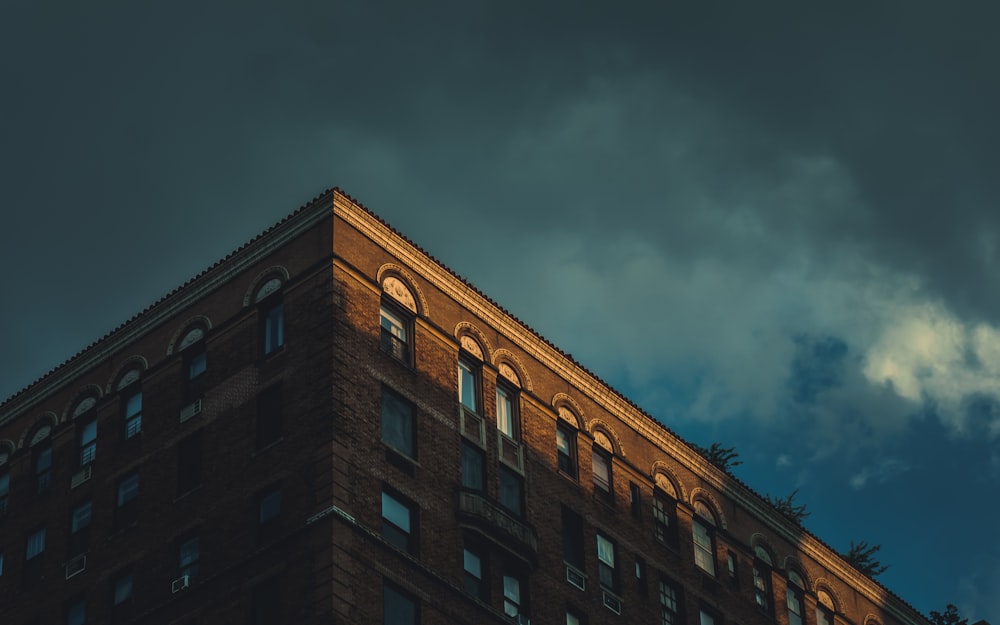 a tall brick building under a cloudy sky
