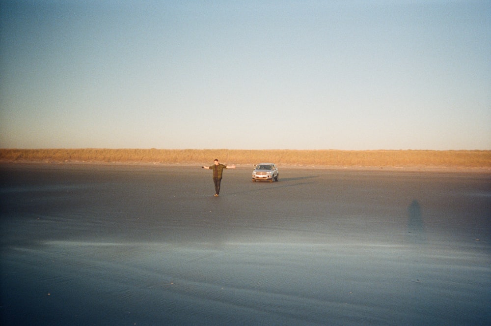 white car on gray sand during daytime